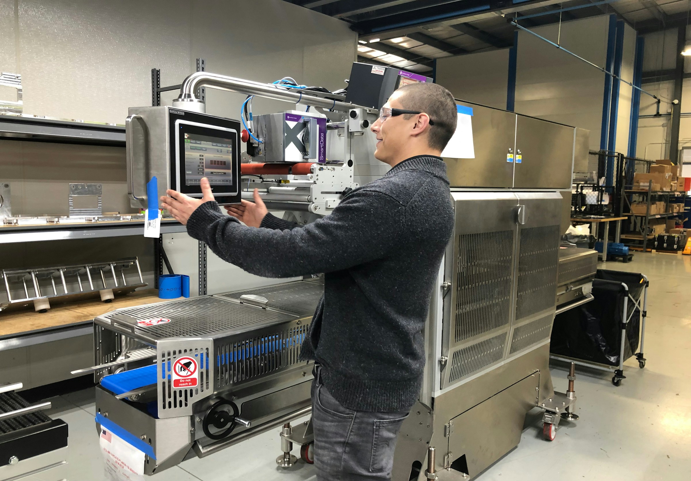 Engineer setting up a single machine using its touchscreen controls